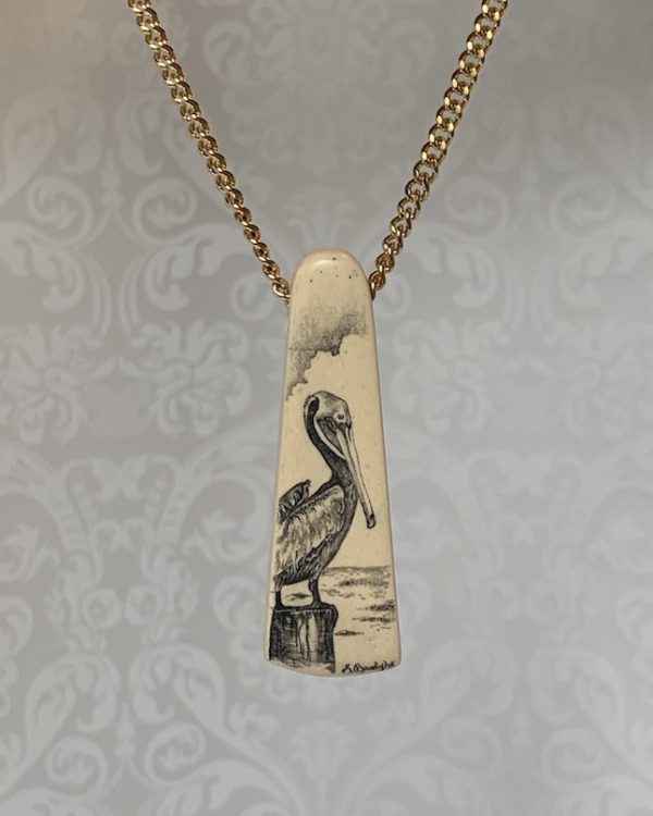 PELICAN SITTING ON PILING SCRIMSHAWED PELICAN