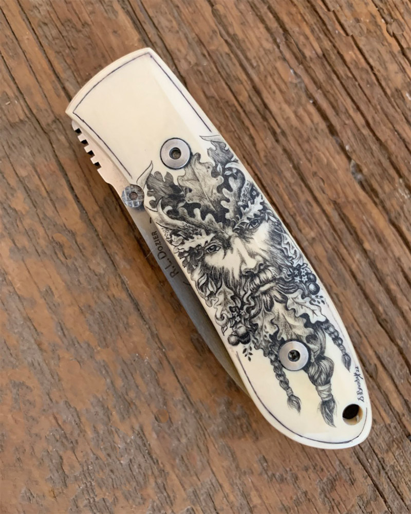 etched leafman face on knife